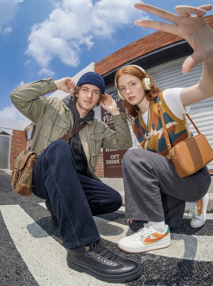Two friends posing in street-style outfits